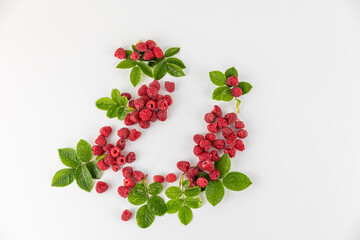 Set of ripe juicy raspberries with leaf isolated on white background.