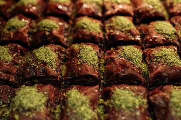 Chocolate honey dessert with pistachio crumble baklava, traditional delicious Turkish sweets