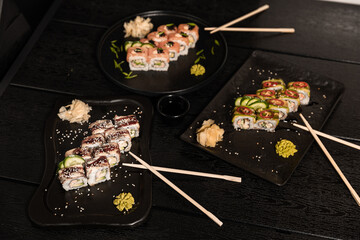 sushi food. Maki ands rolls with tuna, salmon, shrimp, crab and avocado. Top view of assorted sushi. Rainbow sushi roll, uramaki, hosomaki and nigiri.