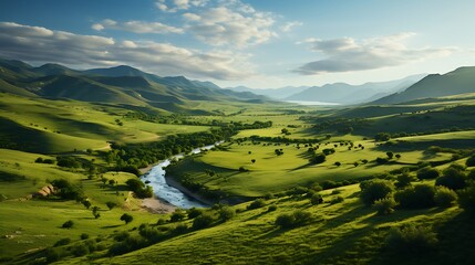 Aerial view of green farmlands with a winding river and mountains in the background at sunset