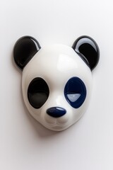A professional product photo of a panda mask with a matte white finish and glossy blue accents around the eyes and ears, featuring a playful contemporary design.