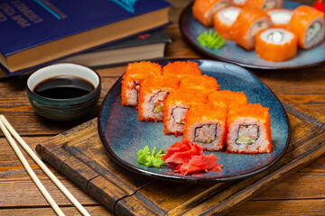 Japanese Philadelphia roll with shrimp on a plate, cafe, restaurant, on a wooden table.