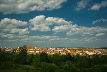 Panoramic view of a European town with red-tiled roofs.