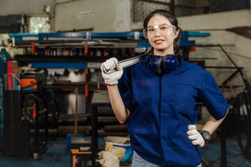 Portrait engineer women working in Lathe shop with metal machinery lathe milling machine, confident...