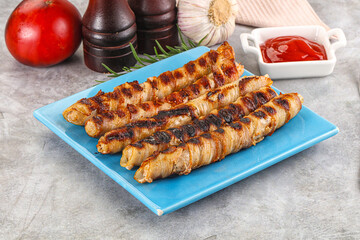 Grilled meat sausages wrapped bacon