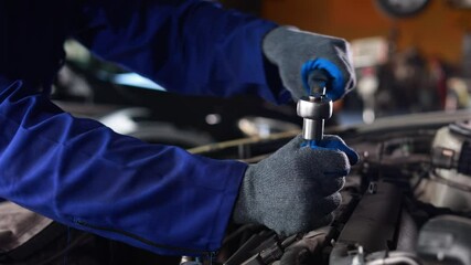 Slowmotion. Close up mechanical hand with tools and spanner. Hispanic latin male mechanic repairs car in garage. Car maintenance and auto service garage concept - Powered by Adobe