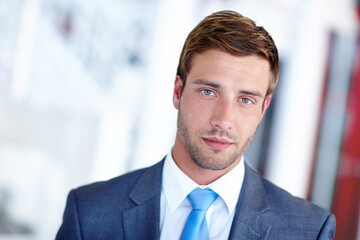 Portrait, businessman and serious with confidence, suit and pride as accountant for financial agency. Male person, professional and office for investment opportunity, portfolio and banking in company