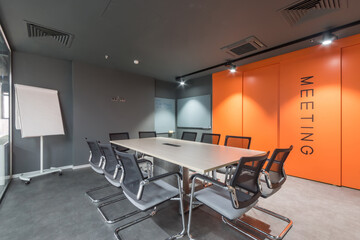 Meeting room in a modern office. A combination of gray and orange in the interior design.