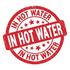 IN HOT WATER text written on red round stamp sign.