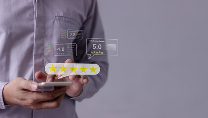 Satisfaction Review, Young Man hand uses smartphone mobile with five star to review and give 5...