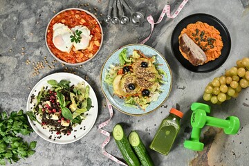 Healthy meal flat lay with nutritious food and fitness elements.