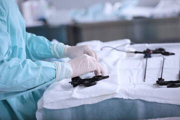Preparation of instruments for laparoscopic surgery. Hands in protective gloves. Modern surgery....