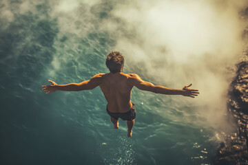 A man is jumping into the water with his arms outstretched. The water is blue and the sky is cloudy