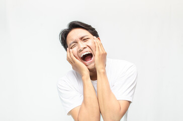 Angry face of young Asian man threatening to cut throat and looking for fight.