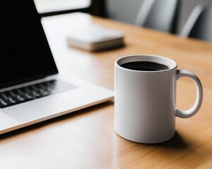 Cup of coffee next to a laptop on a desk - Food and Drink