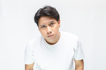 Angry face of young Asian man threatening to cut throat and looking for fight.