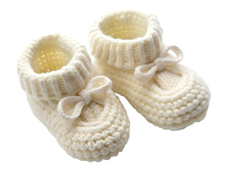 Overhead shot of a set of baby booties in soft white wool isolated on a transparent background