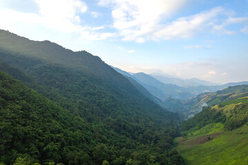 Naklejka premium Aerial view of amazing mountain landscape colorful sunset over the cloudy sky.