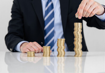 Businessperson Stacking Coins in Increasing Order on Reflective Table, Symbolizing Financial Growth, Investment, and Wealth Management in a Professional Corporate Setting