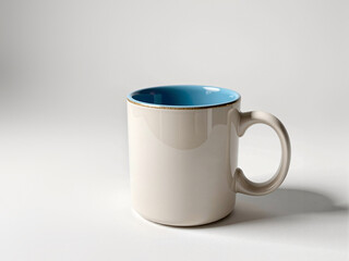 Beige mug standing on white background with blue interior - Powered by Adobe