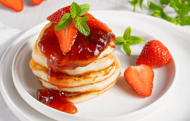 Mini pancakes with strawberry jam and strawberries