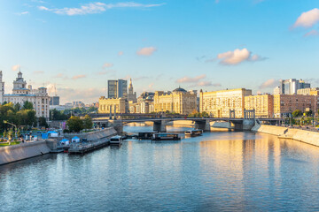 Fototapeta premium Panoramic view Borodinsky bridge, river Moscow, old buildings and high towers. View of the Borodinsky Bridge and the embankment in Moscow