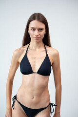 Summer, body and portrait of woman in studio with confidence for fashion and swimwear. Model girl, happiness and bikini for tropical holiday and relax with aesthetics and glow by white background