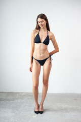 Summer, body and portrait of woman in studio with confidence for fashion and swimwear. Model girl, happiness and bikini for tropical holiday and relax with aesthetics and glow by white background