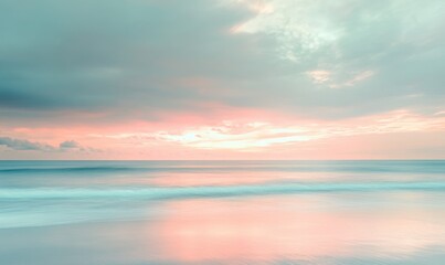 A beautiful sunset over the ocean with a few clouds in the sky