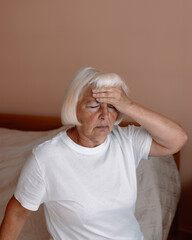 Stressed frustrated middle aged lady suffering from headache massaging temples, close up view. Tired sick mature old woman feeling unwell, touching head. Migraine pain, fatigue, stress concept. High