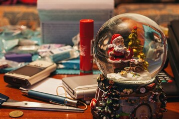 A Christmas ornament with a santa Claus sitting on top of it