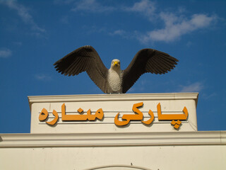 A large eagle with Islamic writing marks the entrance to a park in Erbil, Iraq