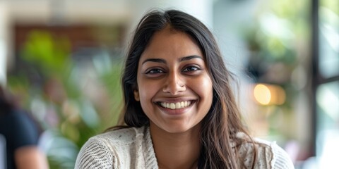 Joyful woman in a professional setting using a tablet for team discussions, planning, and collaboration with colleagues in project management