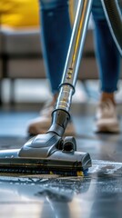Fototapeta premium Home cleaning and maintenance with a vacuum cleaner for dust and dirt in the living area. Household chores and a person using an electric appliance for floor hygiene