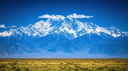Fototapeta premium Majestic snow-capped mountains under a clear sky.