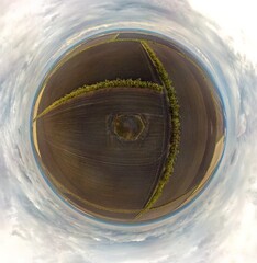 aerial small planet view of ancient burial mound covered with blackthorn bushes with ripe bright...