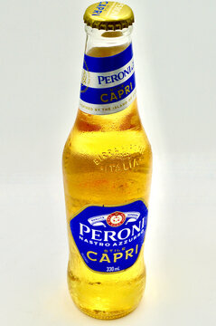 A closeup of a bottle of Peroni Nastro Azurro Stile Capri Italian lager.