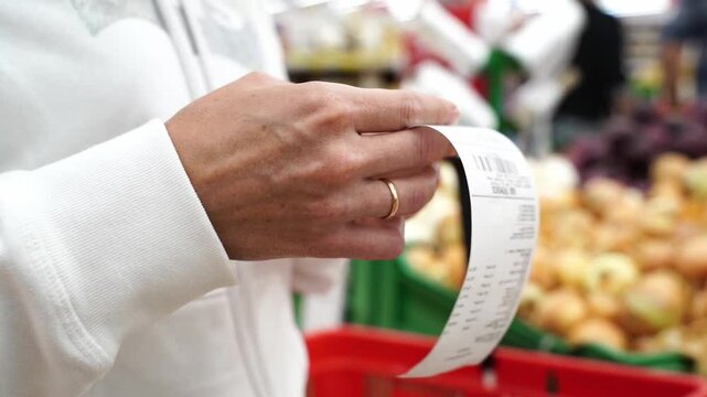 woman with a receipt from a supermarket purchase