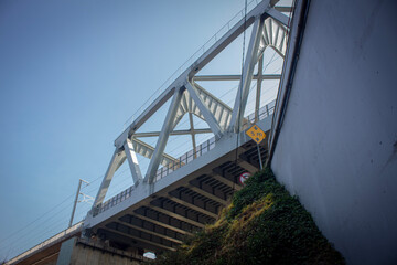 Fototapeta premium Whoosh High-Speed Rail Bridge Cutting Through Indonesia’s Scenery on a Clear Day