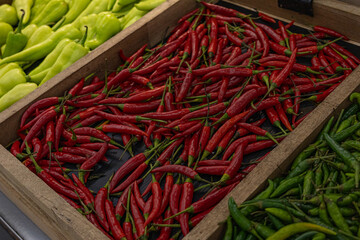 Green and red peppers, on the shelves, in a store In Thailand. Vegetables and food of Asia photos