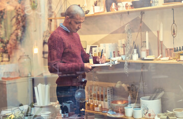 Small business, man and writing on clipboard at organic store or market for checking or counting...