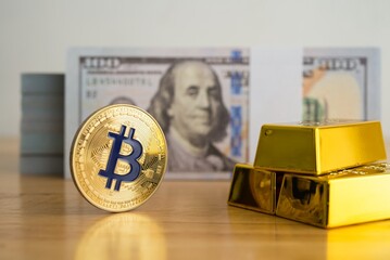 Bitcoin, gold bar and US dollar banknotes on wooden table with white wall background. What is better money? Fiat currency, Gold or Bitcoin cryptocurrency. Economy, financial and investment concept.