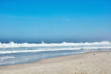 Outdoor, scenery and water in nature, beach and location of environment, waves and summer in destination. Sea, blue sky and tide of ocean, tropical and adventure in morning, paradise and California