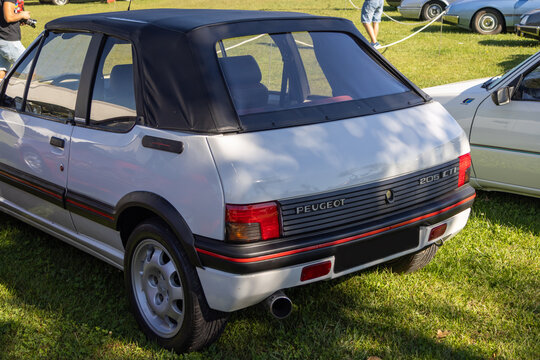 White peugeot 205 cti cabriolet parked on grass at car show