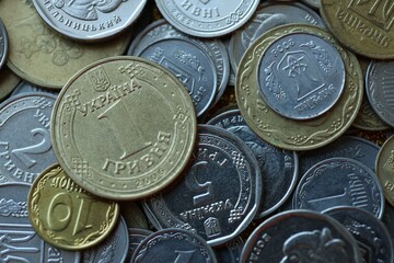 Metal coins of Ukraine of different denominations are scattered. Money texture, business background.