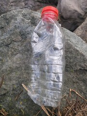 Obraz premium used bottles and plastic with a stone background