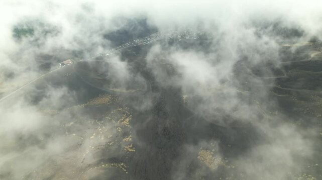 A drone soars high above the dormant crater of Etna. This is a unique journey through the clouds over one of the world&rsquo;s most famous volcanic landscapes, a natural landmark.