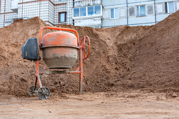 Old concrete mixer at a construction site.