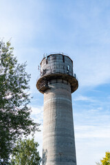Old water tower with cell phone antennas.