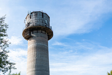 Old water tower with cell phone antennas.